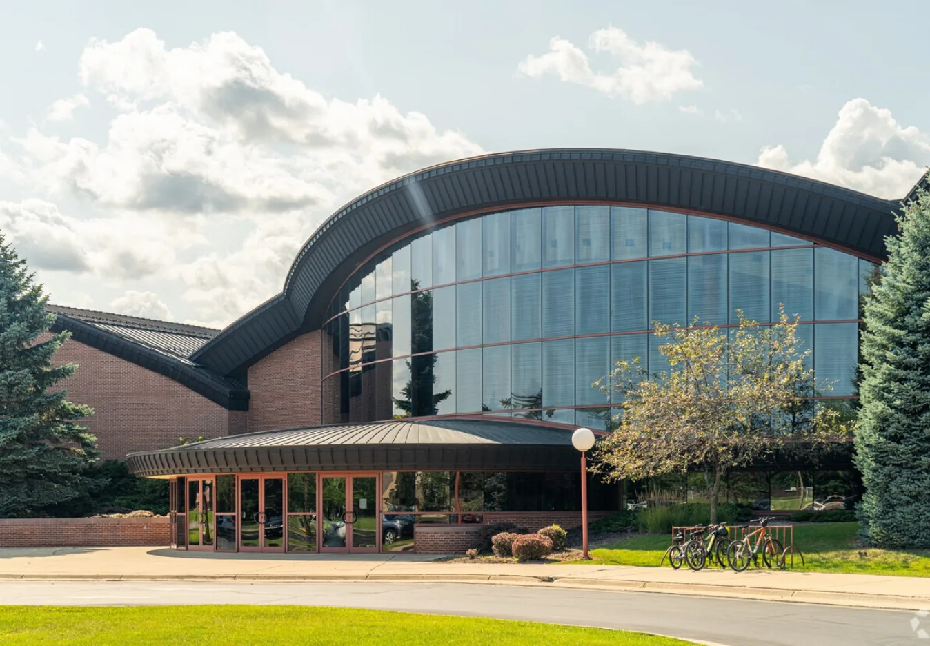 Wind Point Location Harmony Music School's Wind Point location, a brick building with a sweeping curved glass facade